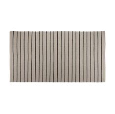 a white and black striped rug on a white background, with vertical stripes in the middle