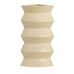 a white vase sitting on top of a table