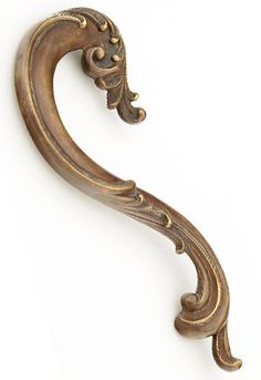 an ornate brass door handle on a white background