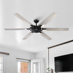 a ceiling fan in a living room with white walls