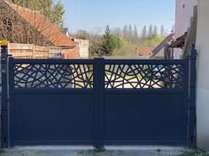 a blue gate that is next to a building