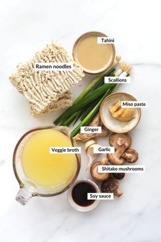 the ingredients to make mushroom soup on a white table