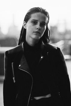 black and white photograph of a woman in a leather jacket looking off to the side