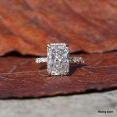 a diamond ring sitting on top of a piece of wood