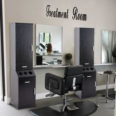 a hair salon with chairs and mirrors in front of the wall that says treatment room