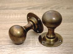 an antique brass door handle on a wooden table