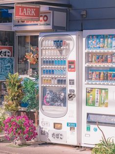 a vending machine sitting in front of a store with lots of sodas and water