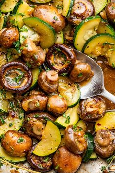 a pan filled with cooked zucchini and mushrooms