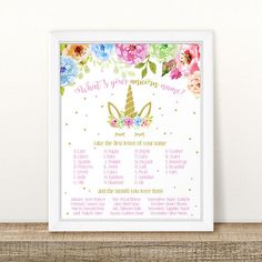 a unicorn themed baby shower sign with flowers on it