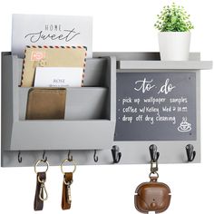 a chalkboard and key holder with hanging hooks