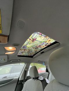 the interior of a car with a stained glass skylight and sunroofer