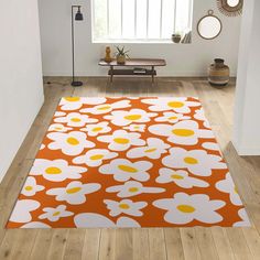 an orange and white rug with flowers on it in front of a window, next to a wooden floor