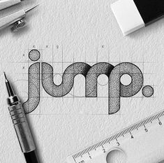 the word jump is drawn on top of a piece of paper next to a ruler