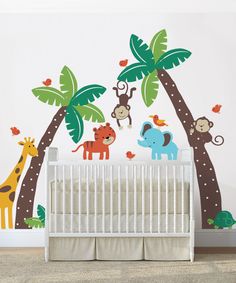 a baby's room with wall decals that include animals and palm trees