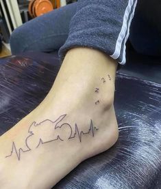 a person with a heartbeat tattoo on their foot