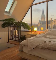 a bedroom with large windows and a cathedral in the background