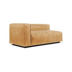 a tan couch sitting on top of a white floor