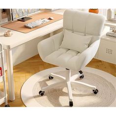 a white office chair sitting on top of a rug in front of a computer desk