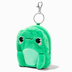 a small green backpack with an animal face on the front and back pocket, attached to a keychain