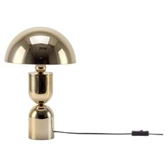 a gold colored table lamp with a black cord attached to the base and a white background