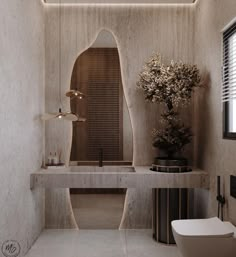 a bathroom with a sink, mirror and vase on the counter in front of it