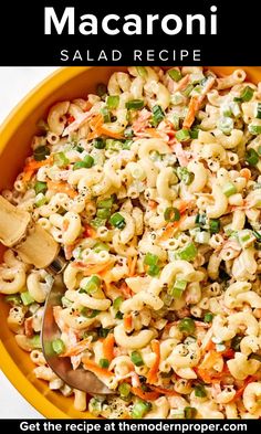 macaroni salad recipe in a yellow bowl with a wooden spoon on the side