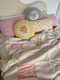 a bed topped with lots of pillows and blankets