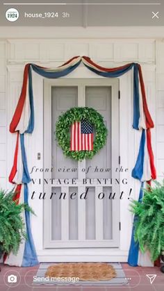 an american flag wreath on the front door of a house