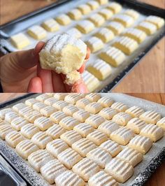 a person is holding a powdered sugar cookie in front of a baking pan filled with cookies