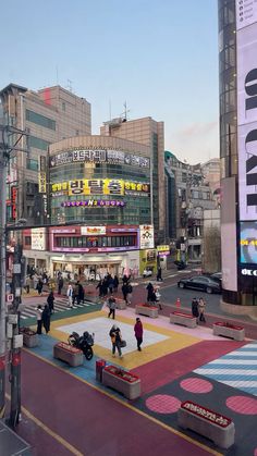 people are walking around in the city near tall buildings