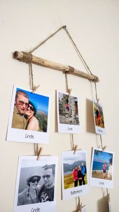 several pictures hanging on a wall with rope and photos pinned to it's sides