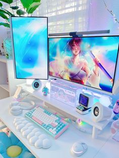 two computer monitors sitting next to each other on top of a white desk in front of a plant