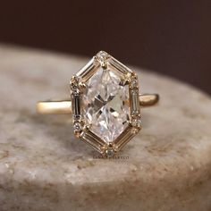 a diamond ring sitting on top of a marble slab