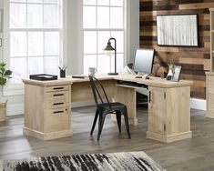 a desk with two chairs and a computer on it