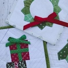 three quilted christmas gifts sitting on top of each other