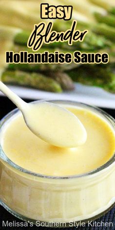 a spoon full of hollandaise sauce with asparagus in the background and text overlay reading easy blender hollandaise sauce