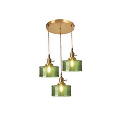 three lights hanging from a ceiling fixture with green glass shades and gold trimmings