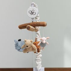 several stuffed animals are hanging from a mobile