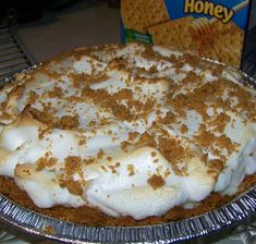 a pie with white frosting and cinnamon crumbs