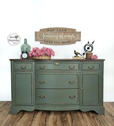 a green dresser with pink flowers on top