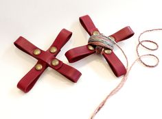 two red crosses are tied up with twine and some other items to make it look like they have been made out of wood