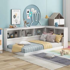 a child's bedroom with blue walls and white furniture