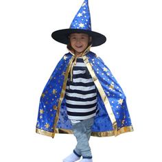 a little boy dressed in a wizard costume and wearing a blue hat with gold stars on it