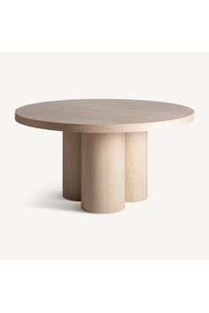 a round wooden table with three pedestals