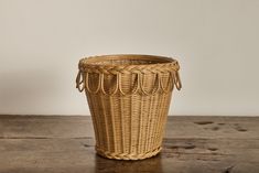 a wicker basket sitting on top of a wooden table