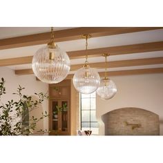 three glass globe lights hanging from the ceiling