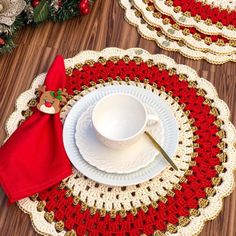 crocheted placemats with red and gold trim on wooden floor next to christmas decorations