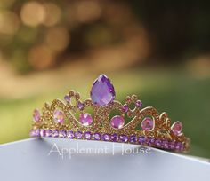 a purple tiara sitting on top of a white table