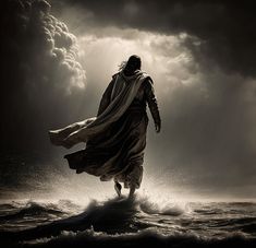 a man walking in the water with his arms spread wide and wearing a long robe