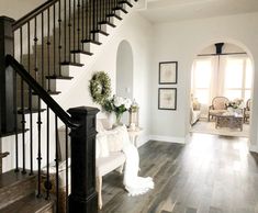 a living room filled with furniture and a staircase